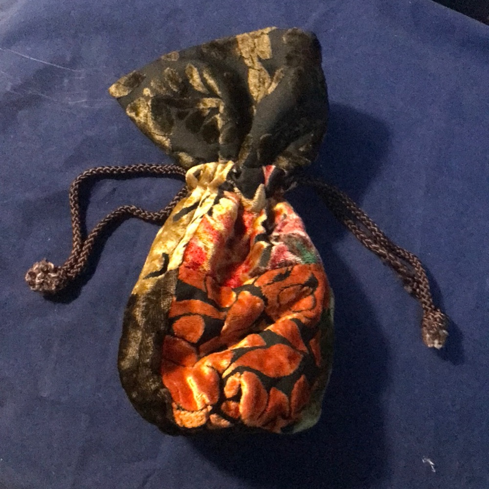 Stone Ridge multicolored purse with shoulder strap and draw string options.